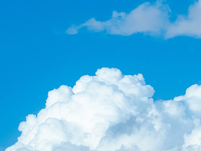 A clear blue sky with clouds representing clean air in commercial and industrial businesses.