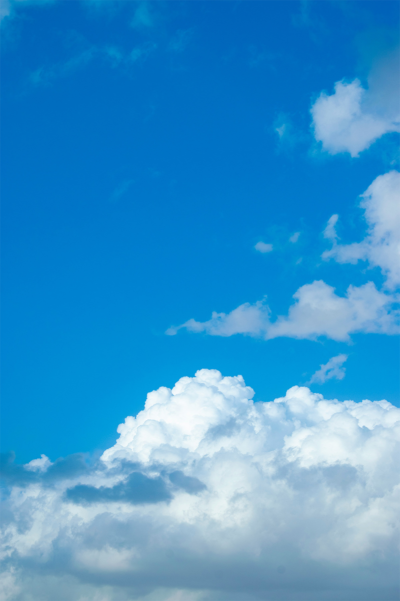 A blue clear sky and clouds representing clean air in commercial and industrial businesses.