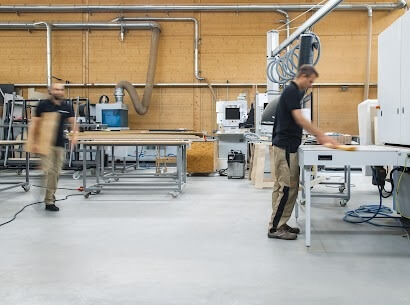 Machine operators working on projects in a commercial facility.