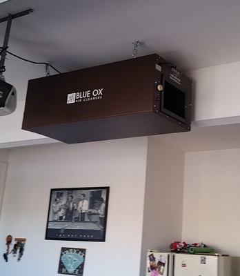 Blue Ox OX1100 residential air cleaner installed in home garage for cigarette and tobacco smoke and odor removal.