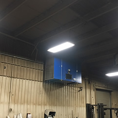 Blue Ox Air Cleaner shown in construction equipment facility to extract weld and plasma cutting smoke.