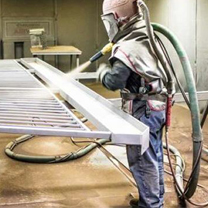 Image of worker doing industrial blasting