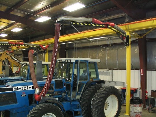 Tractor in a shop connected to a diesel exhaust removal system