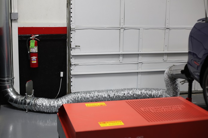 Vehicle exhaust ducting with hose removing dyno exhaust.