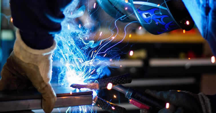 Worker welding producing welding smoke