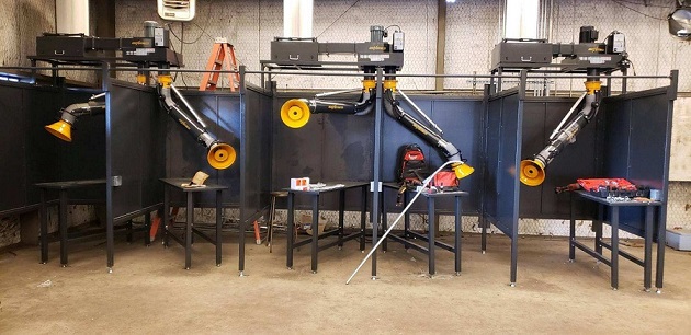FumeXtractors welding booths and fume arms installed in a high school workshop.